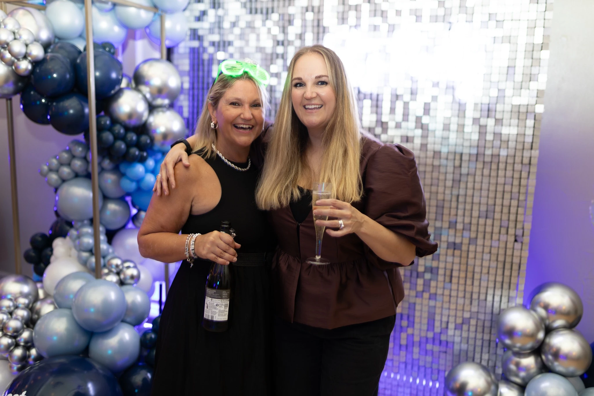 Two Bluestorm directors holding a drink at the celebration party